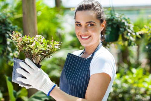 A professional gardener in Harefield reviewing garden hazards before work